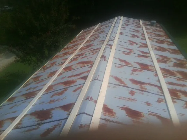 Rusted metal roof panels with new wood purlins before replacement — Storm Damage Roof Repair in Lake Geneva by Roofing Brothers