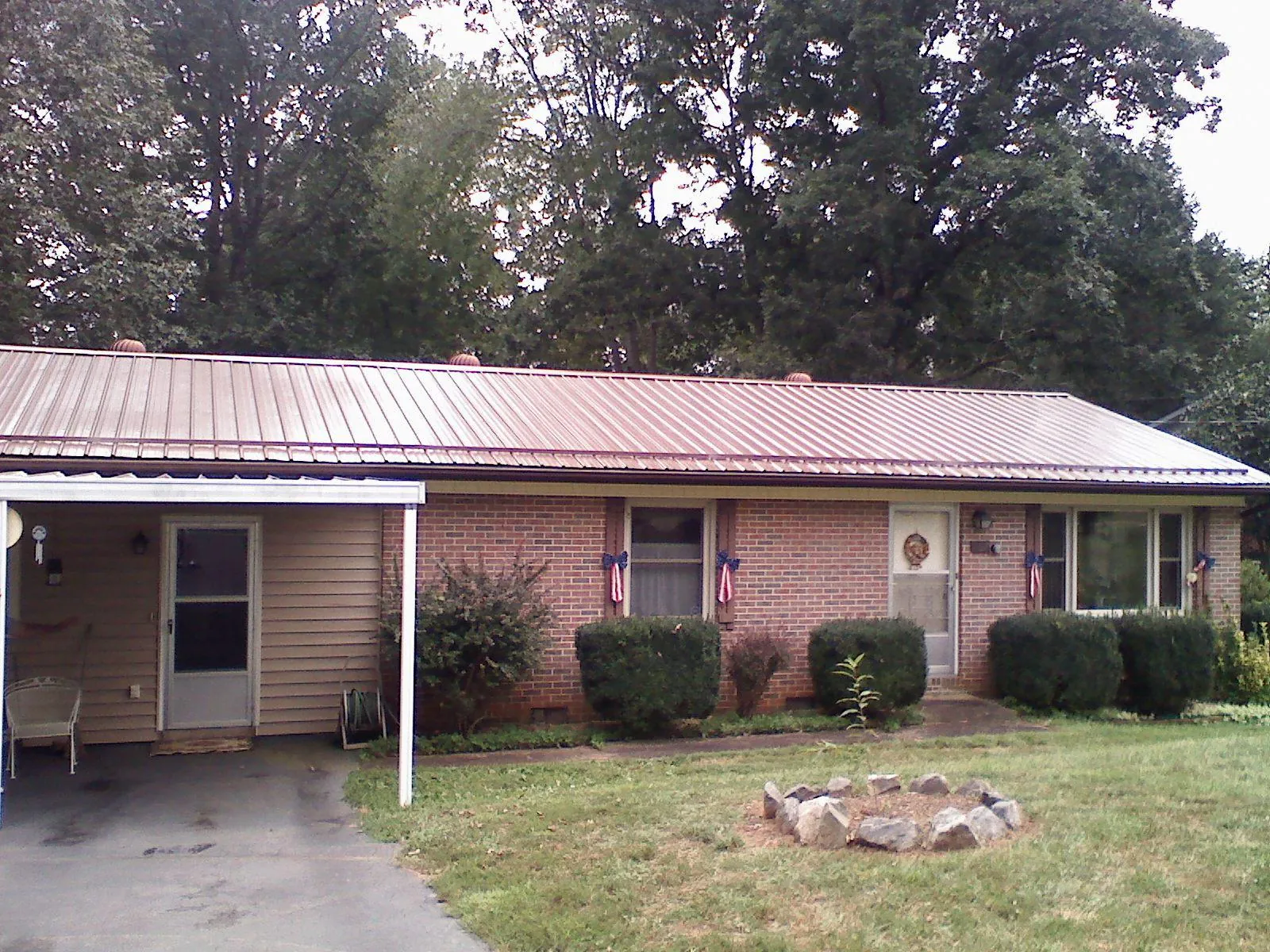 Bronze metal roof and carport on a brick ranch home in Lake Geneva
