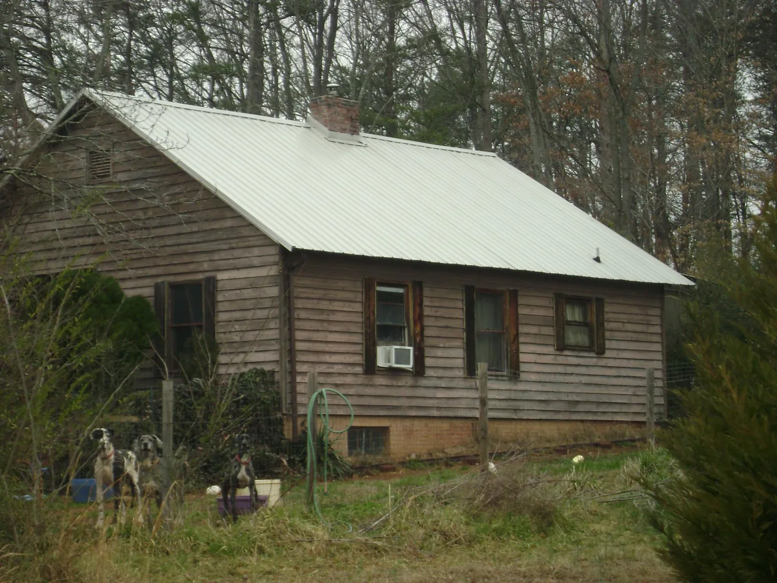 White metal roof on an old wood sided farmhouse, from a Metal Roof Installation job in Lake Geneva